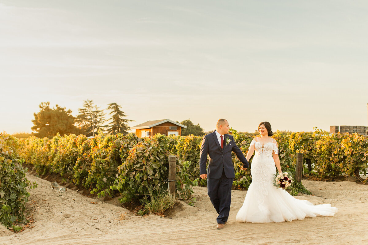 wedding-couple-walking-vineyard