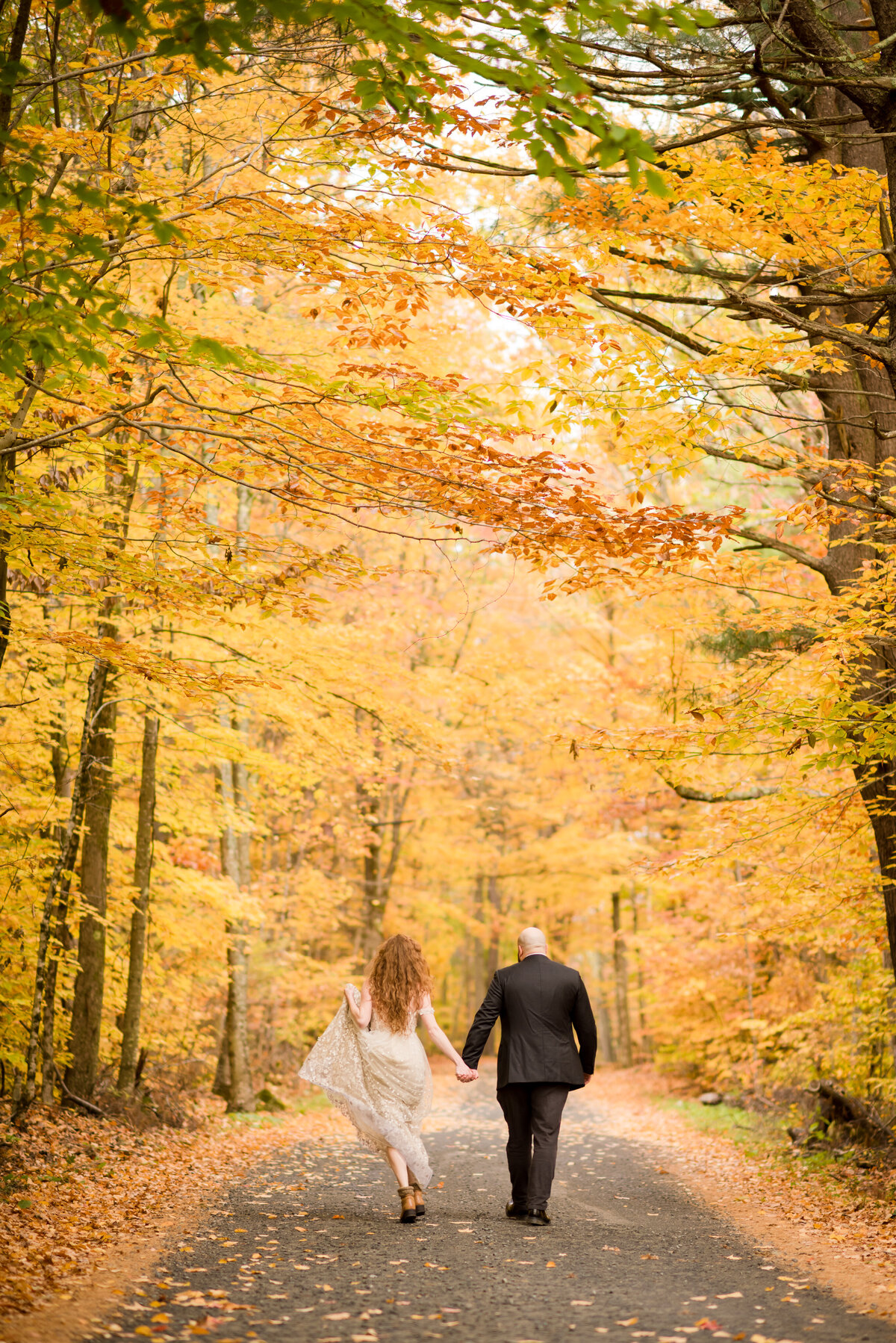bride and groom skipping away toward their ceremony location