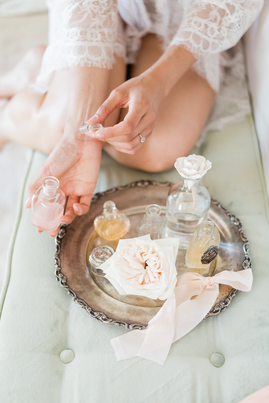 close up of a bride wearing perfume 