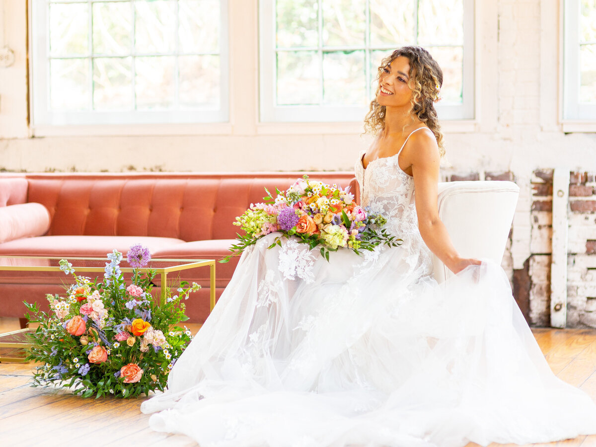 Bride holding wedding bouquet and her wedding dress