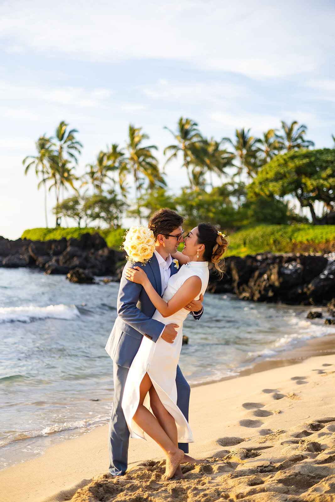 bride and groom kissing on the beach