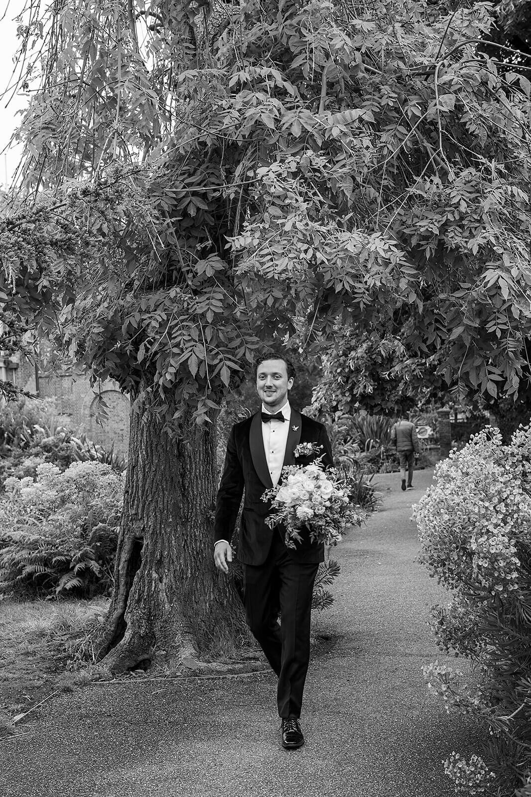 Groom walking through London park