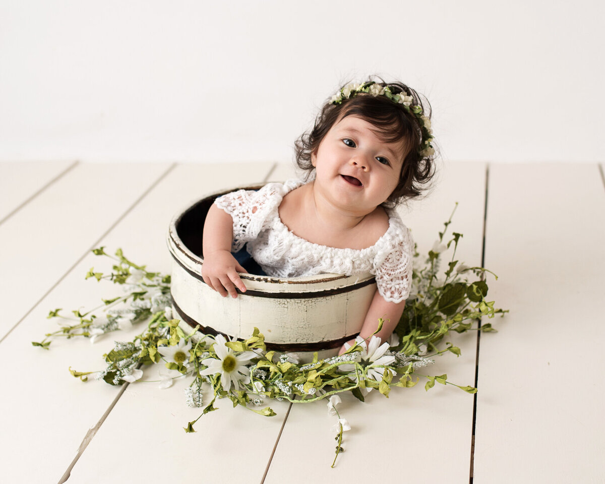 Lovely baby in a flowery bucket and flower headdress photoshoot in Houston