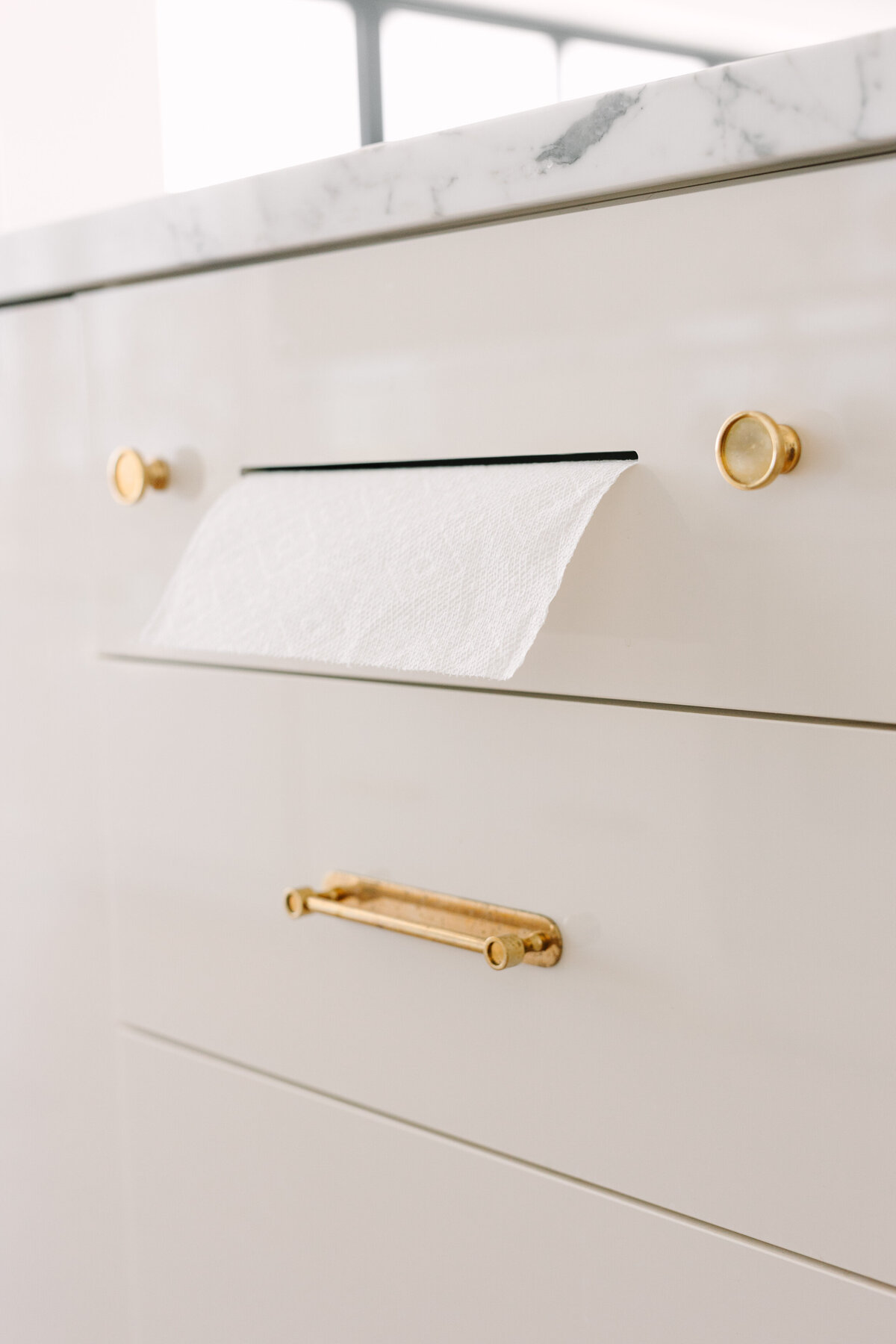 Kitchen with built in paper towel holder drawer.