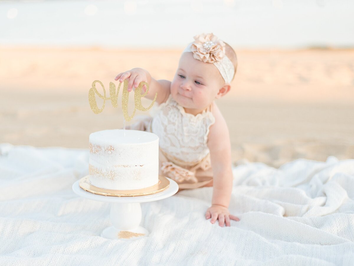 one year old crawling towards cake