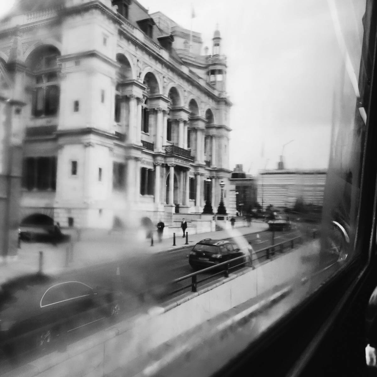 Elegant European building with arched windows and historic details along a city street — evoking urban elegance and the curated sophistication of custom travel planning.