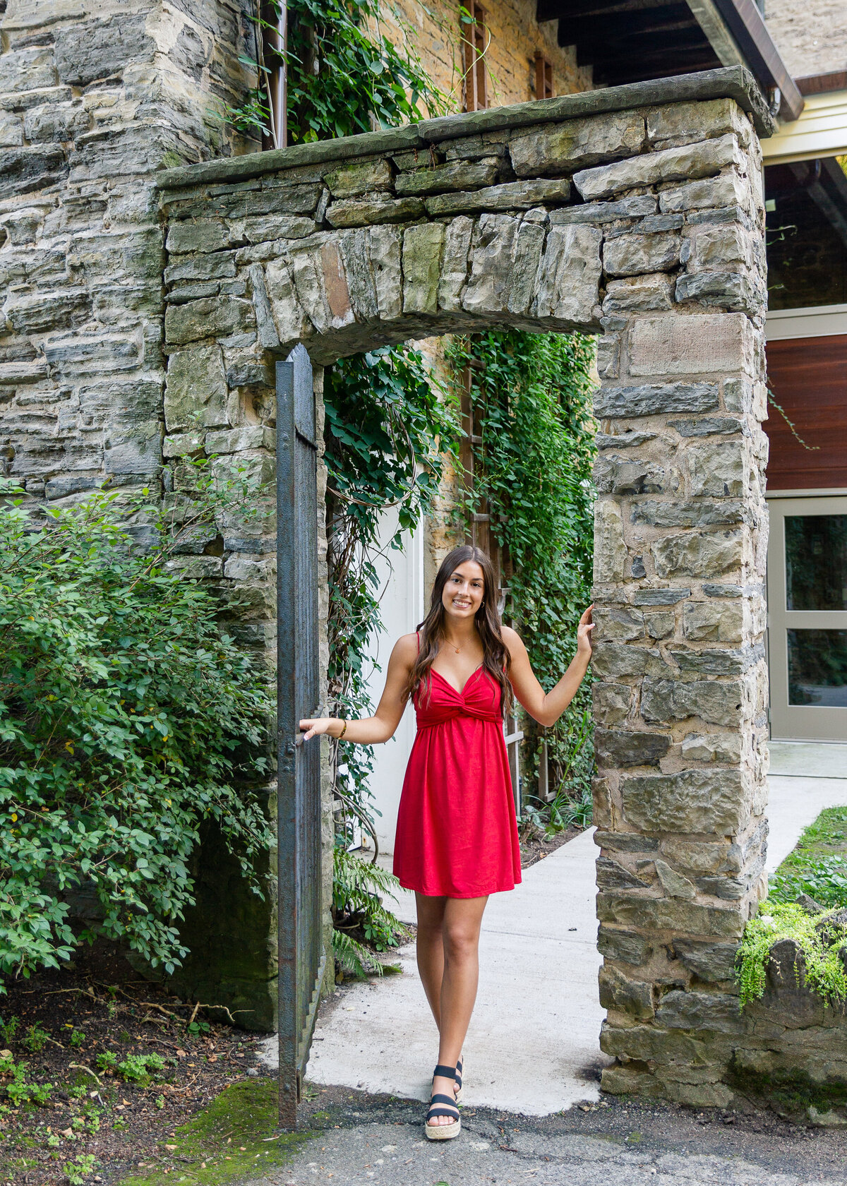 Beautiful Senior pictures of girl in a red dress taken at Warner Castle in Rochester, NY