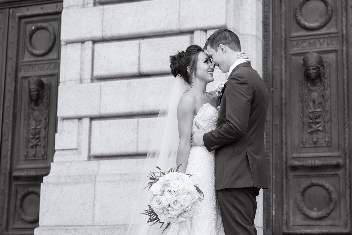 Bride and groom embrace each other happily on their wedding day, behind an old Courthouse located in Ohio. Photographed by Columbus Wedding Photographer Aaron Aldhizer