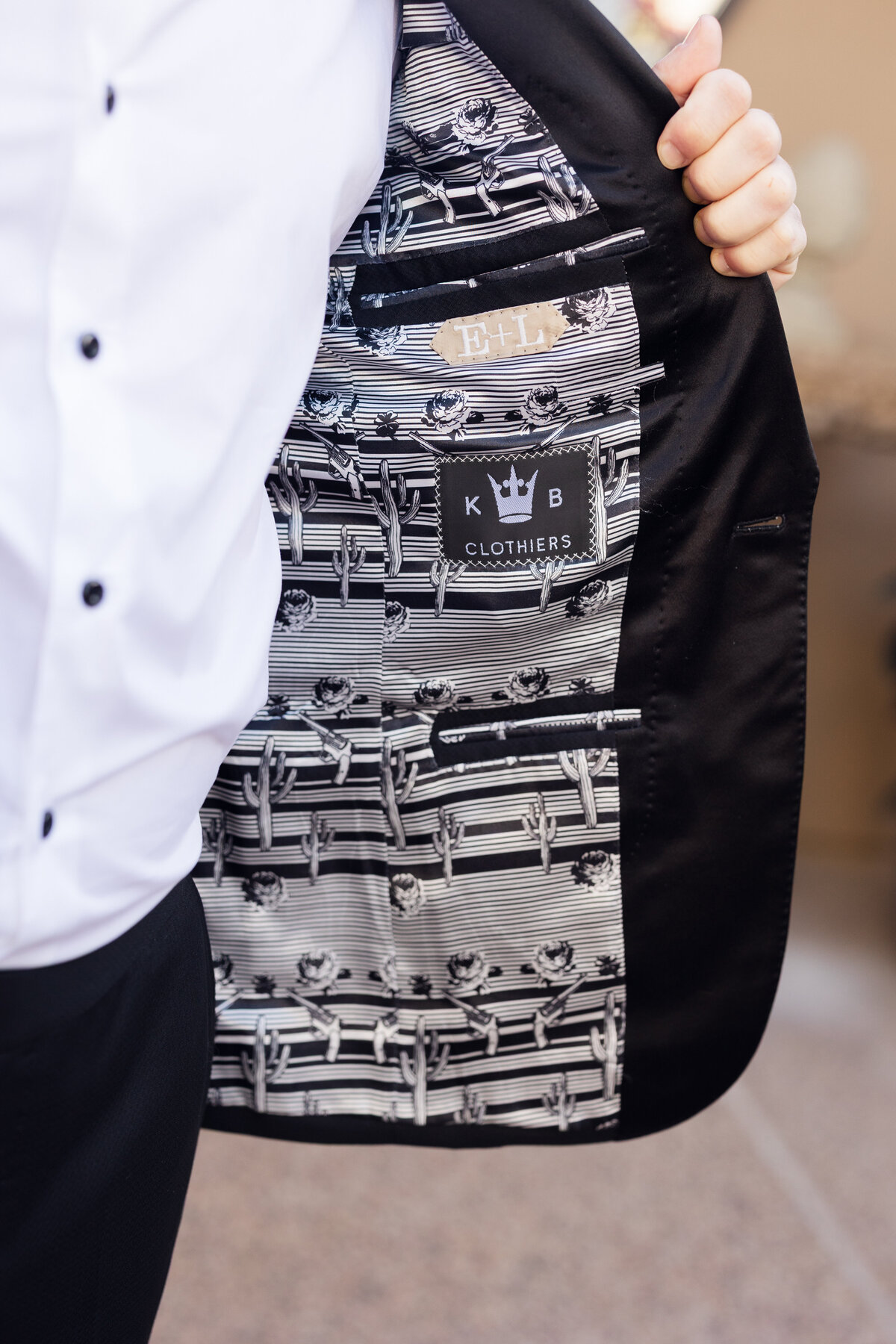 Closeup detail of groom's suit jacket on wedding day