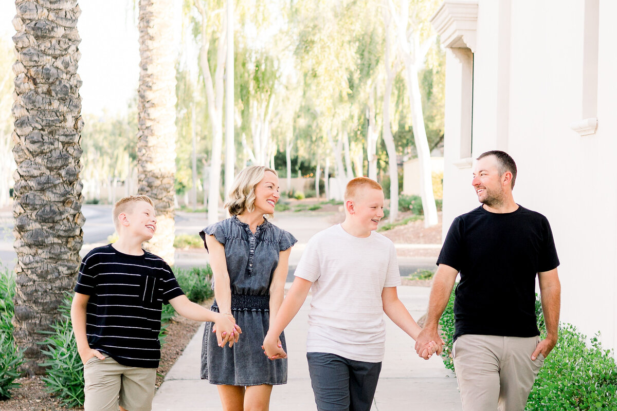 Family of four holding hands at a family photography session in Verrado, Arizona.