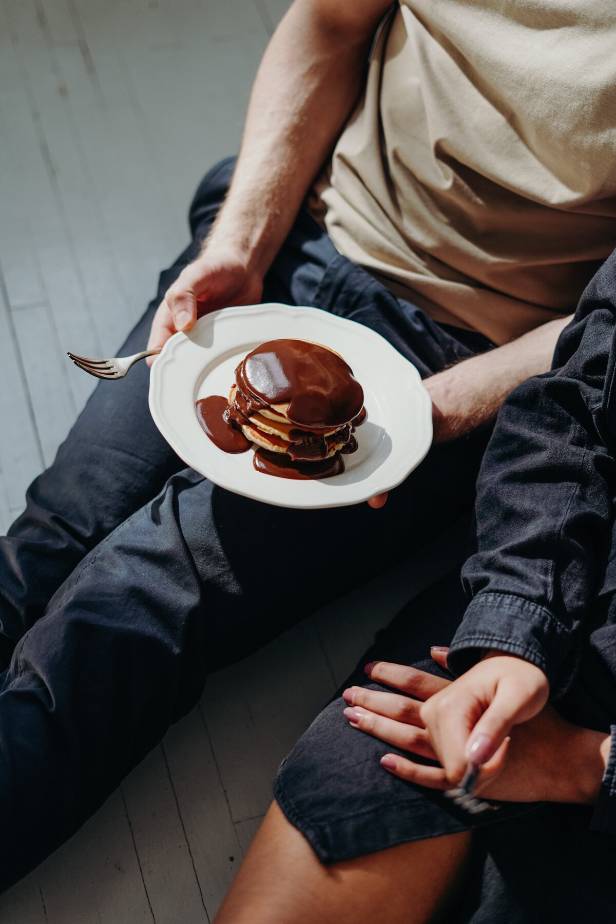 person-holding-plate-with-chocolate-pancakes-3692871