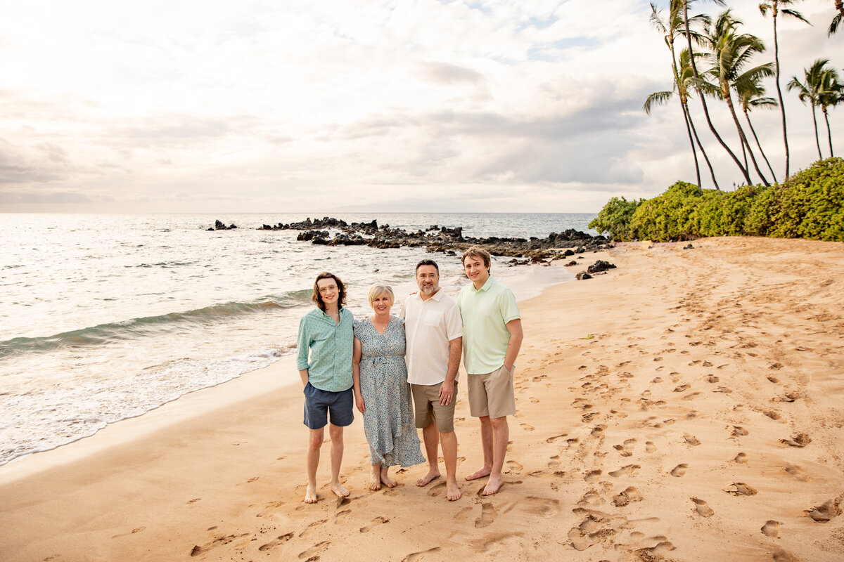 Maui Family Photographers capture young family standing on beach together