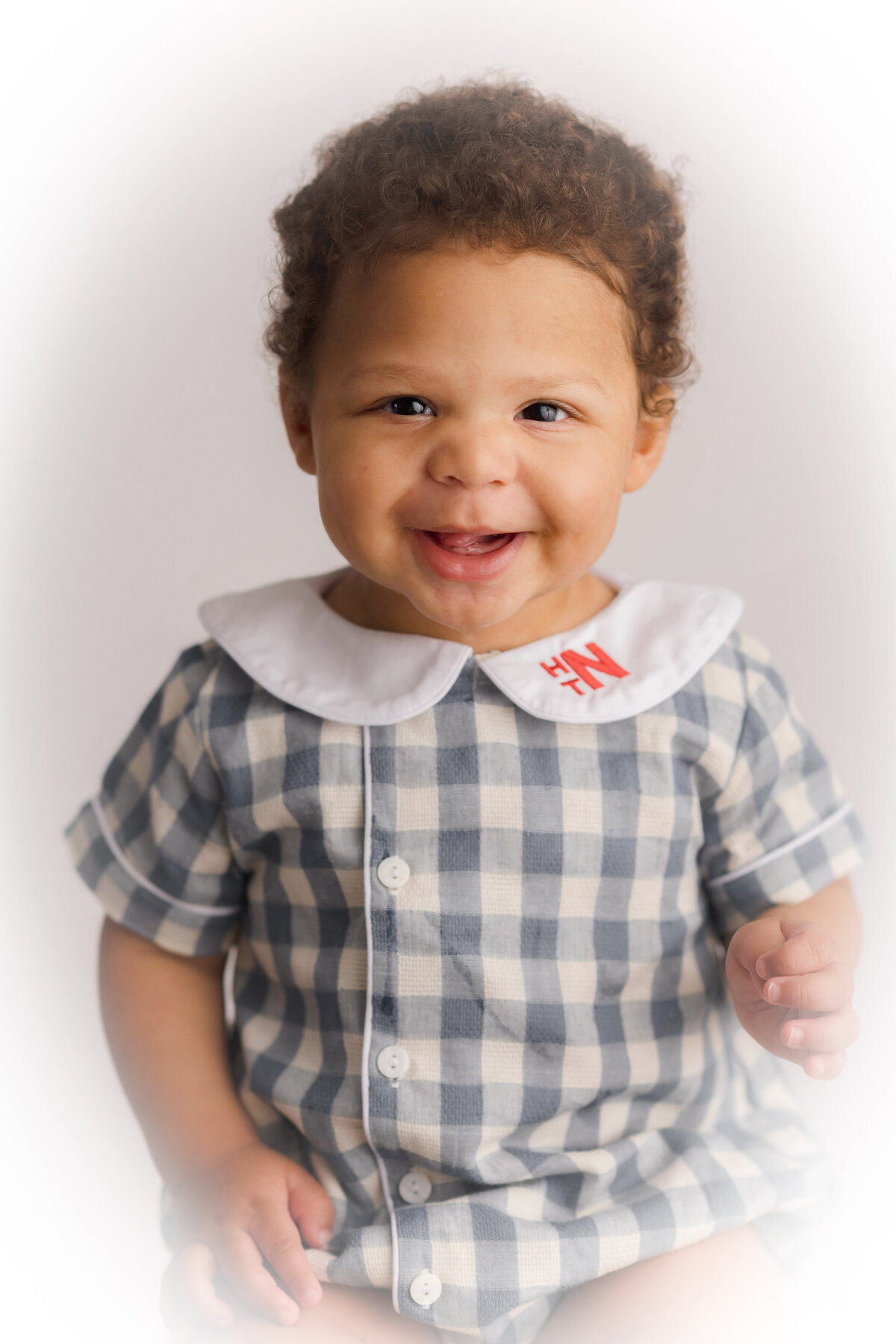 Baby boy smiles at the camera during Heirloom Portrait Photography Session in Charleston, SC. 