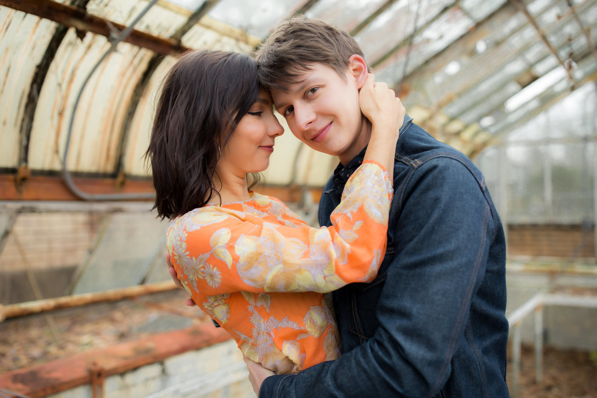 engaged couple hugging for atlanta wedding photographer at briarcliff mansion greenhouse