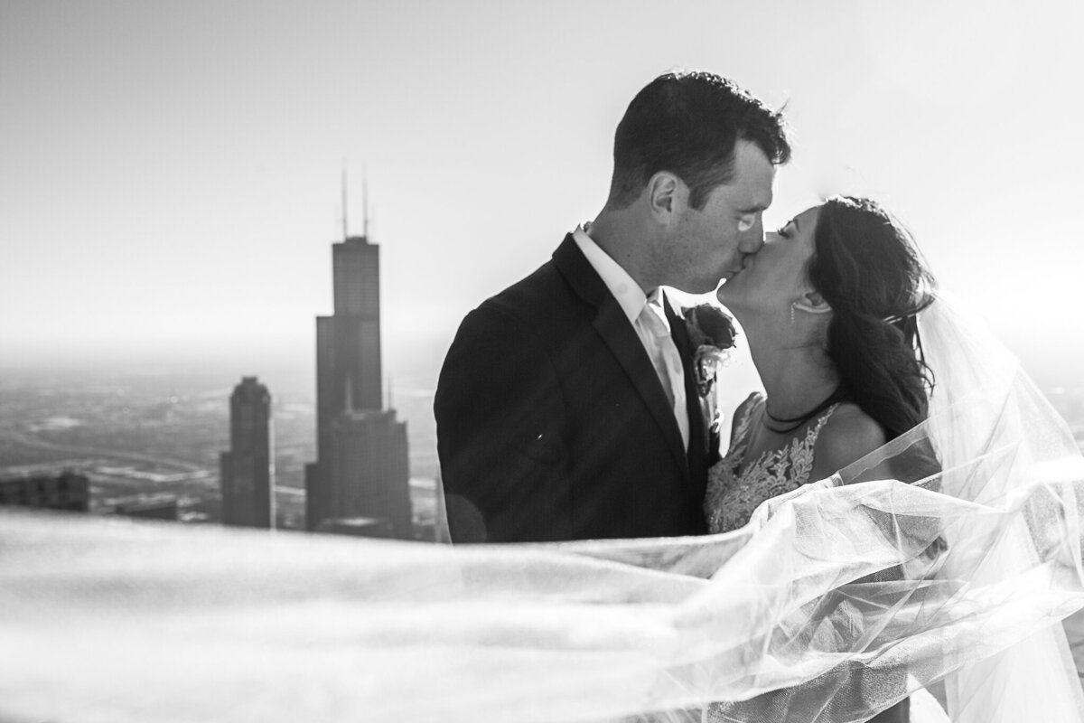 downtown-chicago-wedding-photography-veil-shot-rooftop-bride-groom-kissing