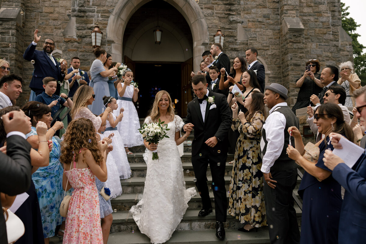 groom holding bride holding bridal bouquet in studio