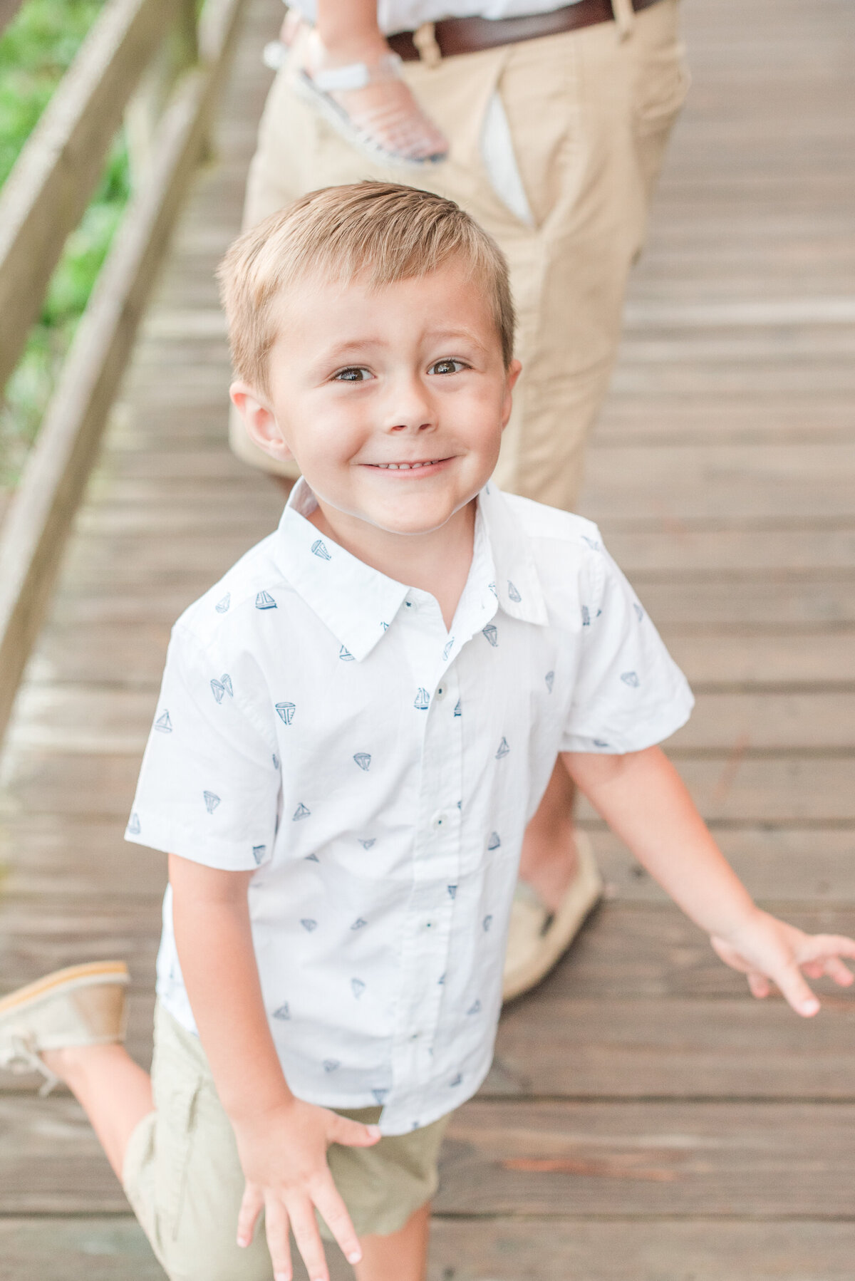 little boy in nautical button up smiling at camera