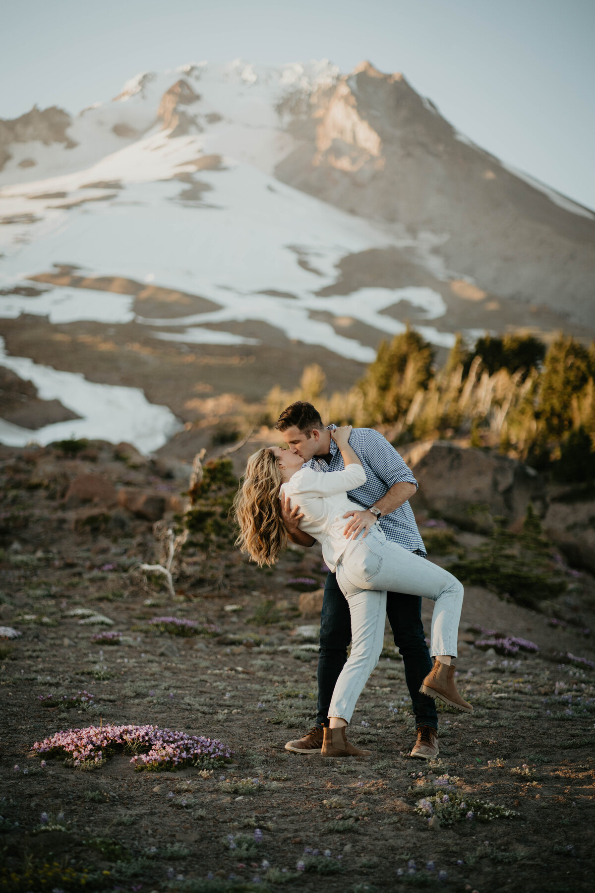 Couple kissing in front of Mt. Hood at Timberline Lodge
