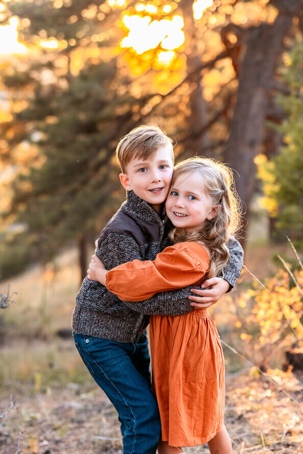 Two siblings hug for family photos.