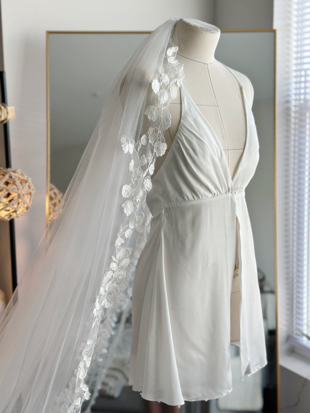 Soft ivory bridal slip dress with gentle drape and subtle shimmer
