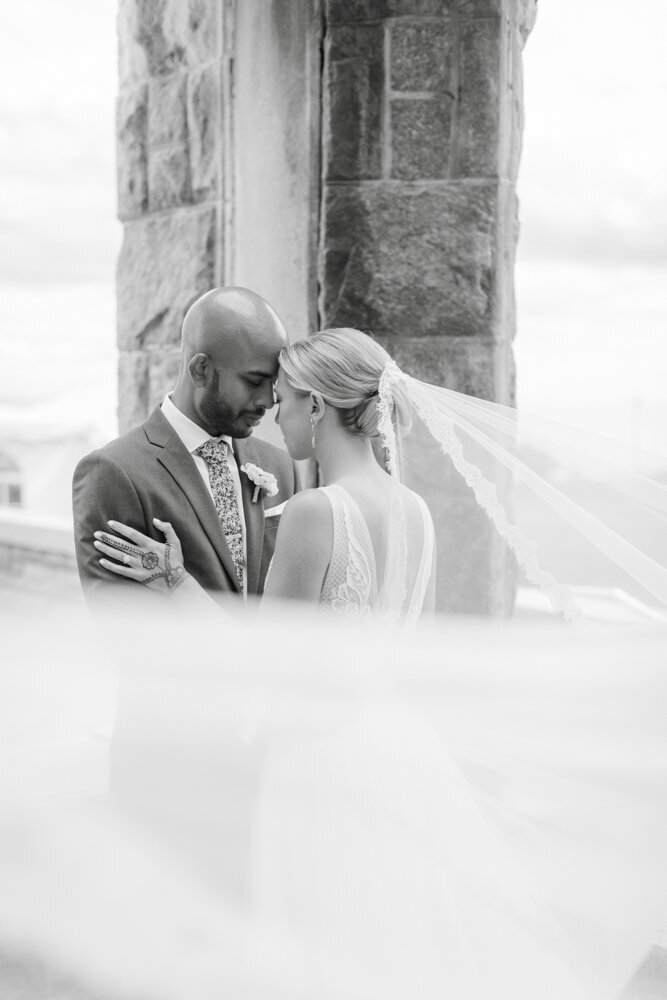 black and white portrait of bride and groom with long veil - gold shoes and wedding details - branford house wedding