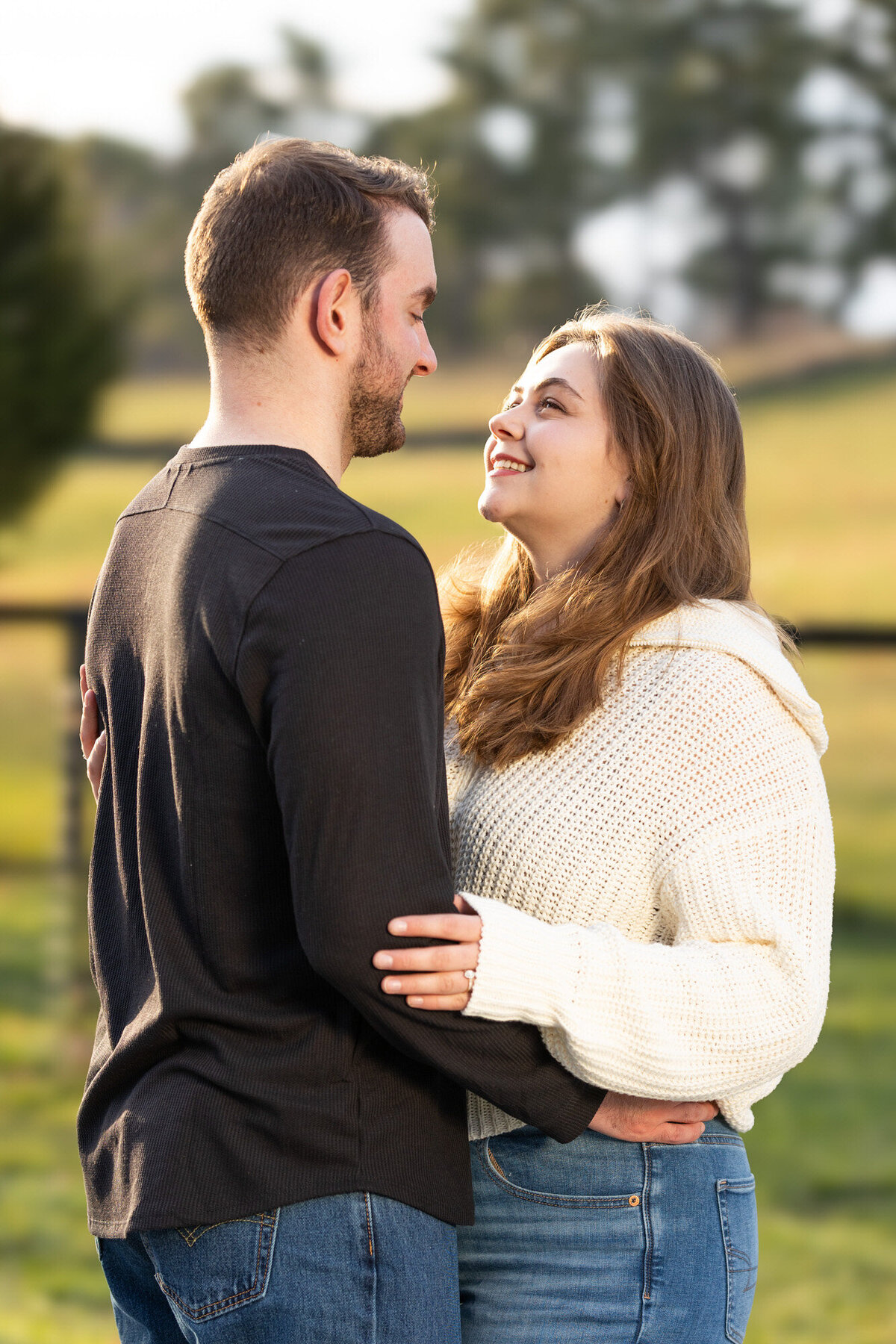 Couple photos at Virginia State Arboretum holding each other and smiling