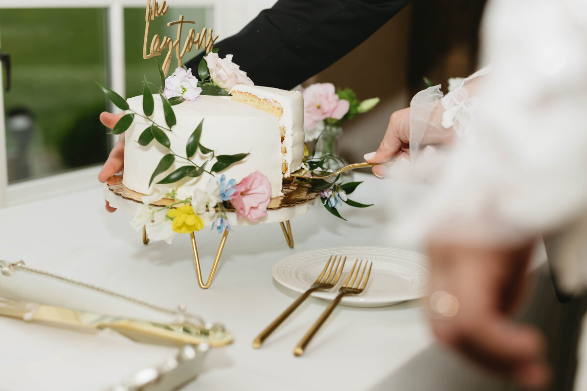 Colorful wedding cake floral decor designed by Abby Grace Florals at NC wedding