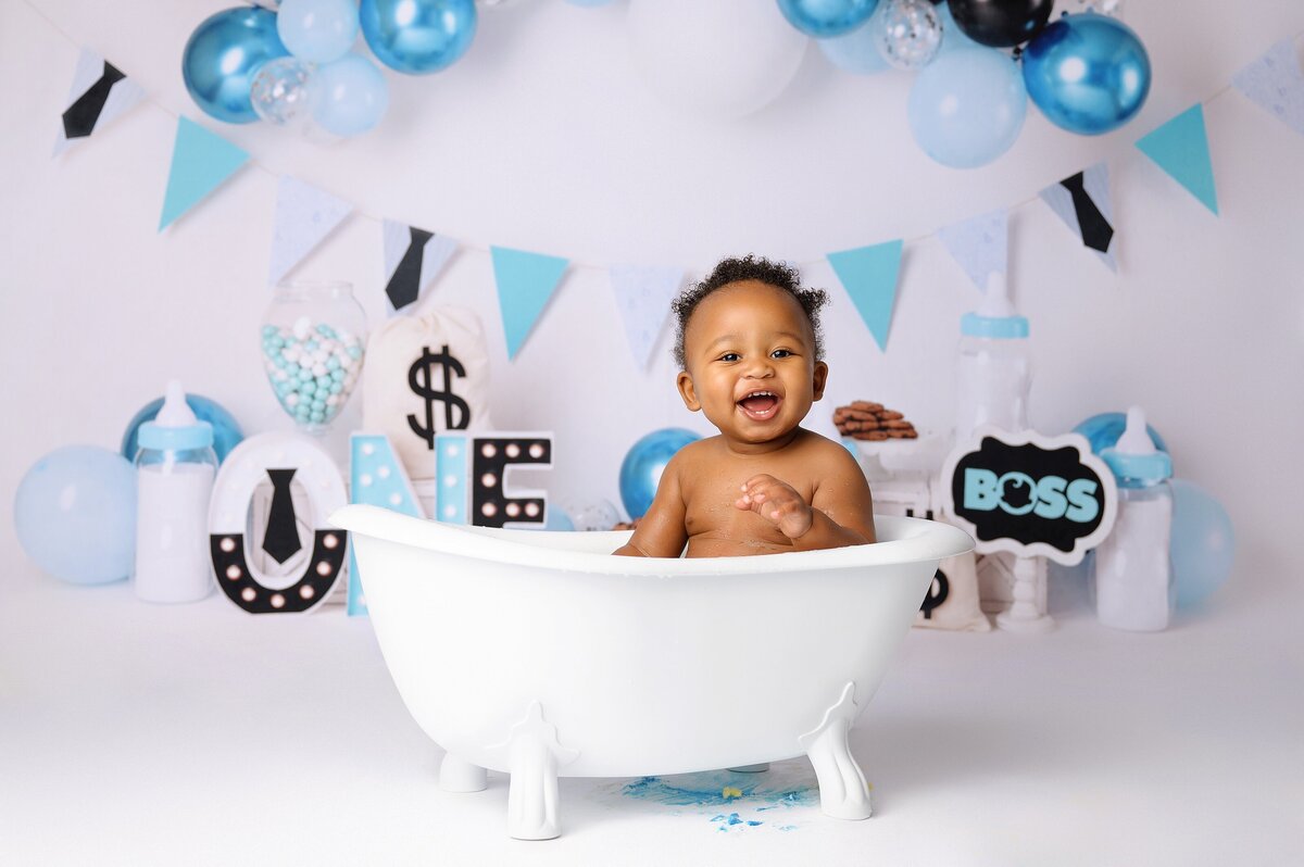 Baby celebrates turning one with a boss baby themed splash bath after his cake smash session in West Palm Beach, FL.