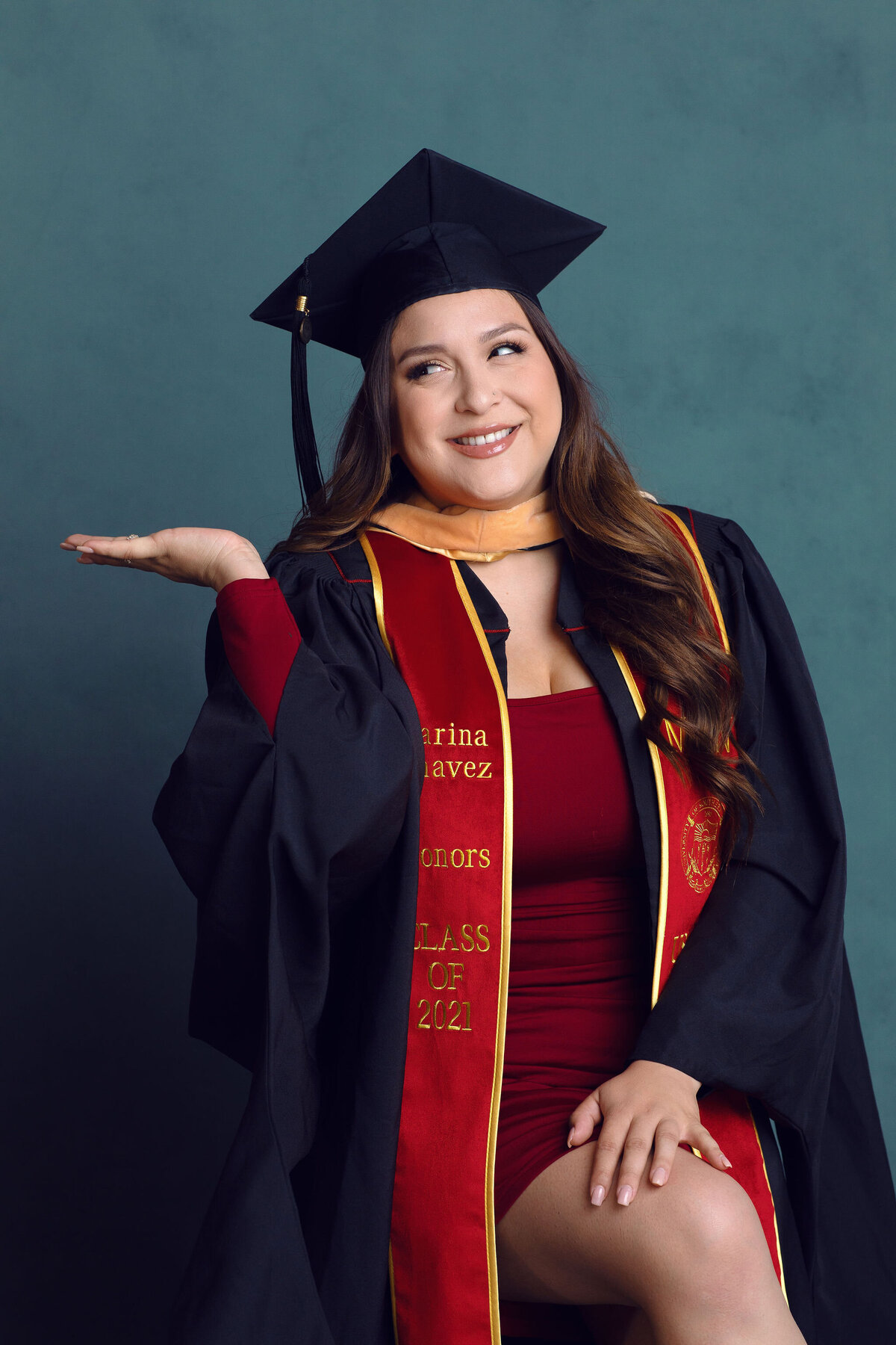 Graduation Portrait Of Young Woman In Black Toga And Inner Red Dress Los Angeles