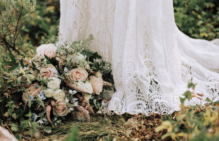 bridal-bouquet-sitting-at-the-base-of-brides-lace-dress - Copy