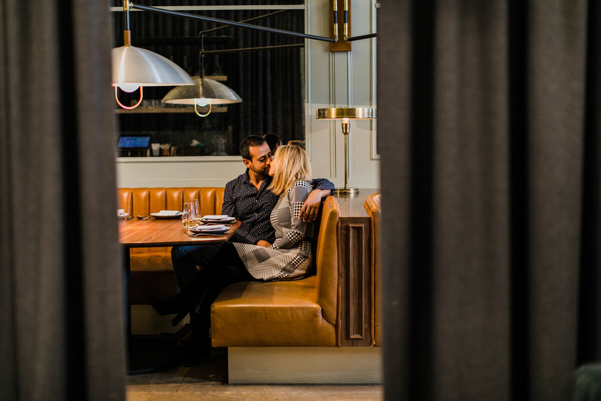 A couple poses for an engagement photo in their favorite West Loop bar in Chicago