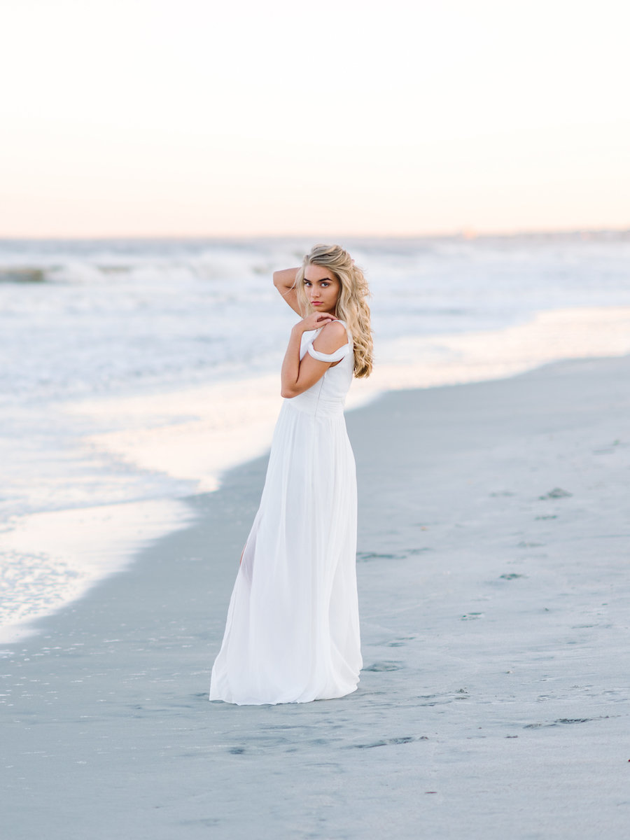 A Stunning White Dress looks beautiful in the beach setting during your senior portrait session