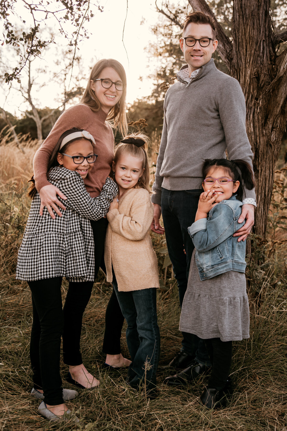 Family in field for San Antonio photography session at golden hour