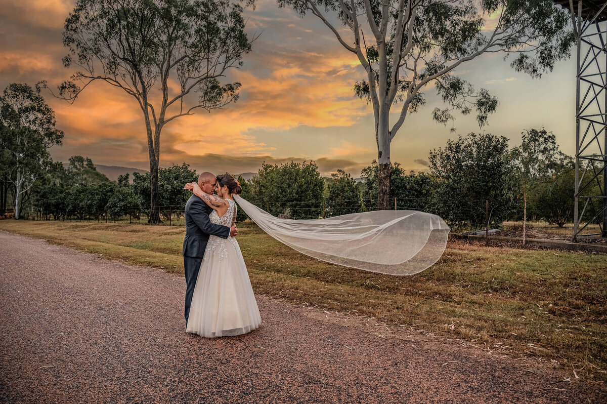 A romantic wedding scene captured at the old mill, showcasing love and joy amidst rustic charm and natural beauty. - photo by Jamie Simmons