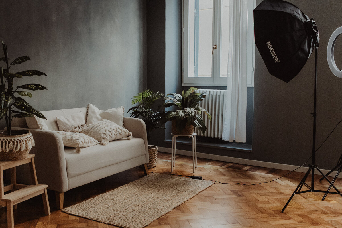 Angolo dello studio con fiori freschi, specchio dorato e arredi eleganti, atmosfera intima e curata nei minimi dettagli