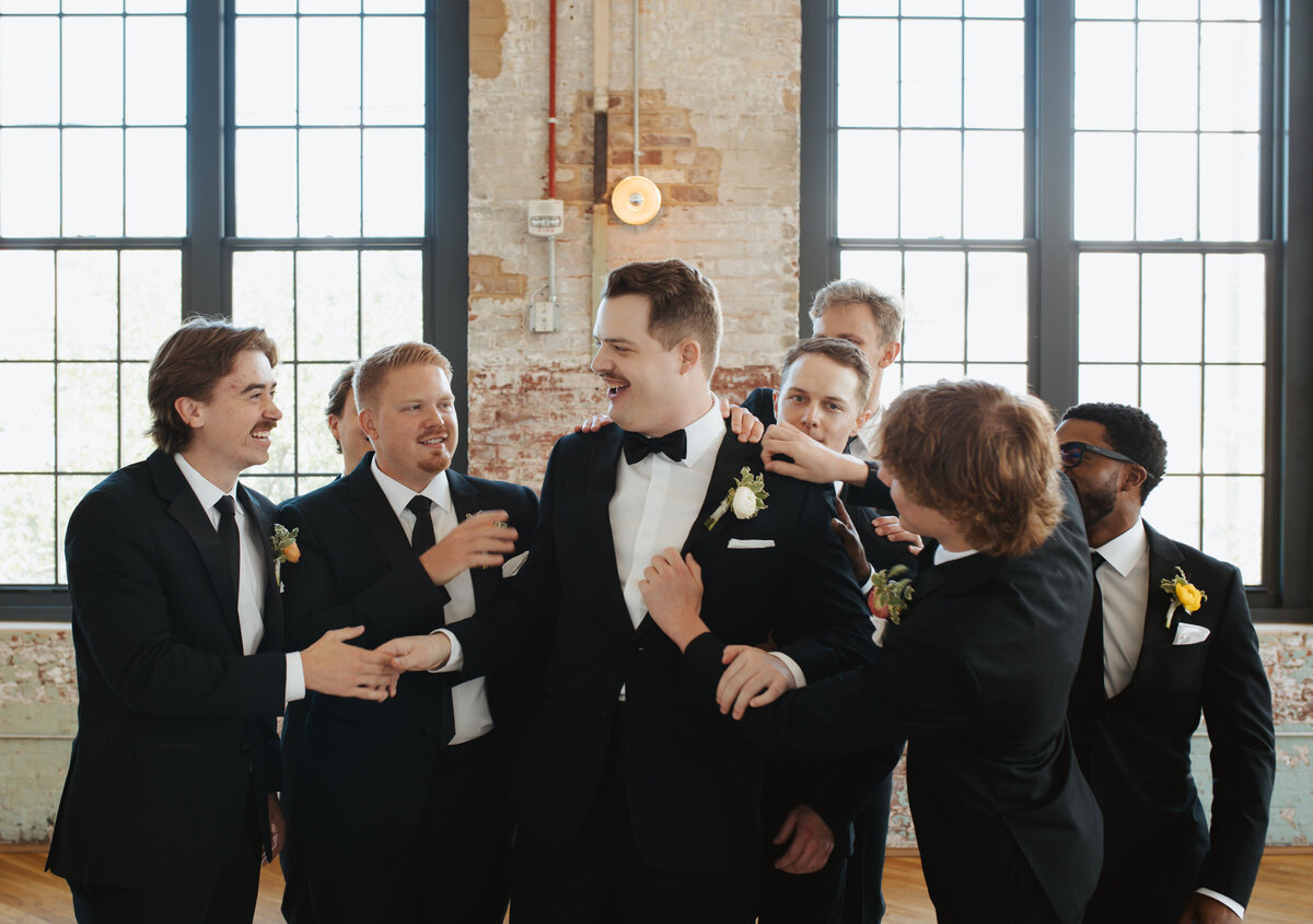 groom and groomsmen laughing during photos