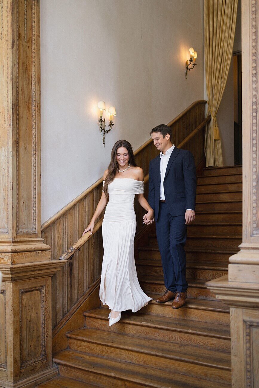 Couple walking and holding hands while walking down stairs at Peter and Paul