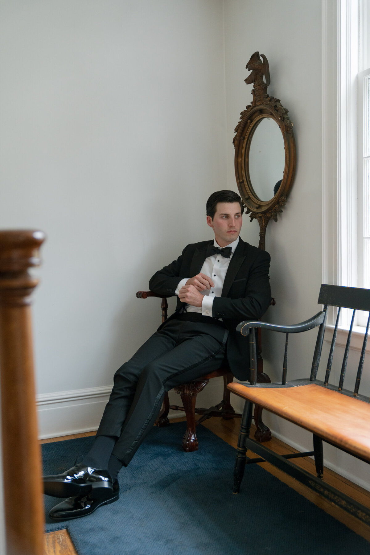 Groom posing in chair taken by film wedding photographer shelby ann photos