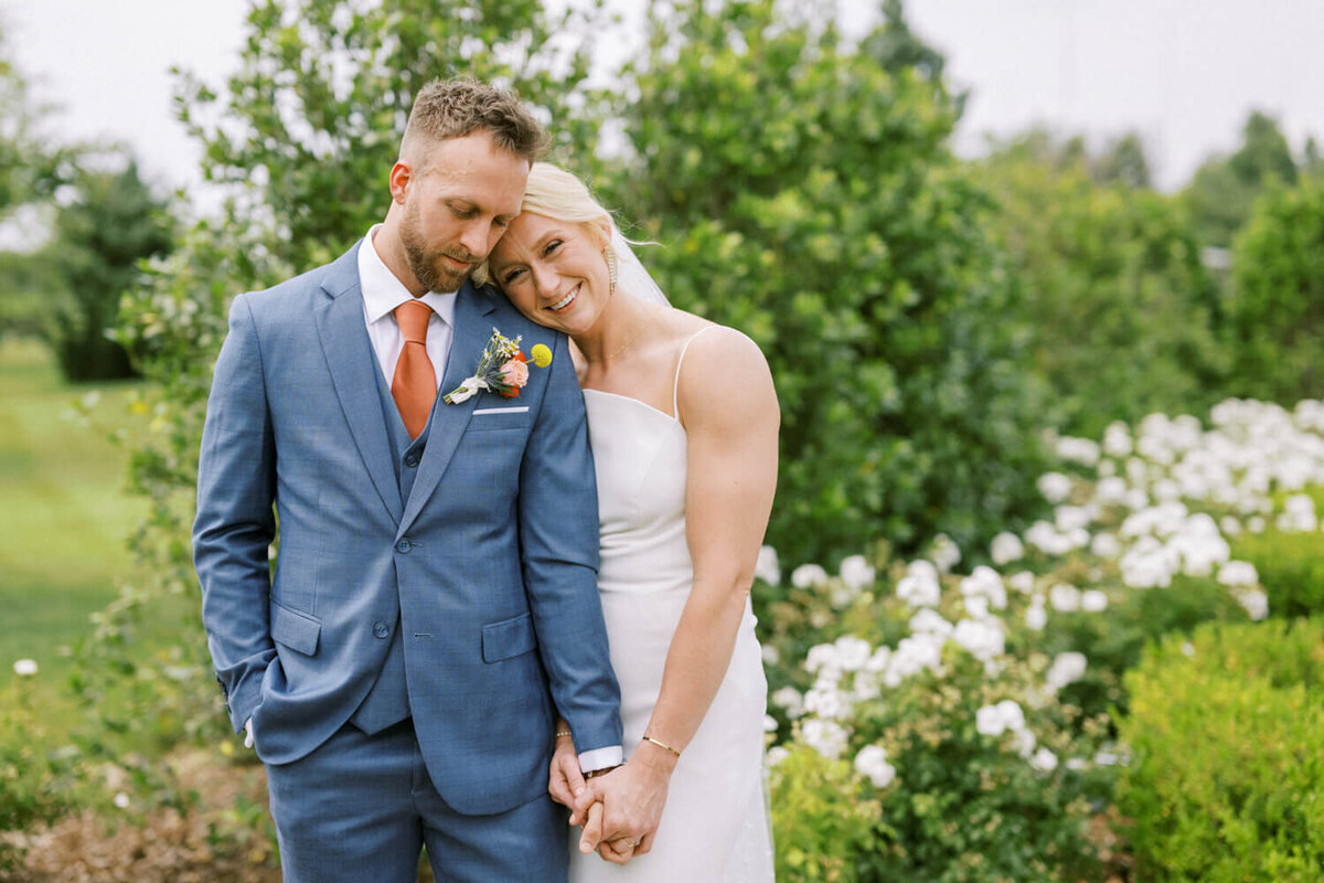 bride-holding-grooms-hand-during-portrait