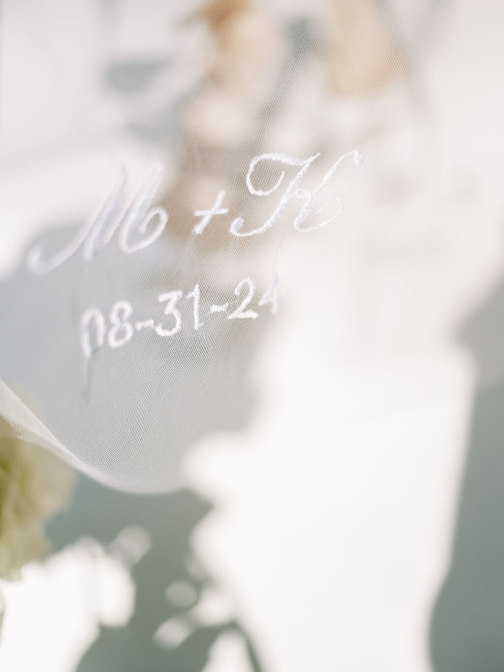 A delicate embroidery of the couple’s initials and wedding date on a sheer veil.