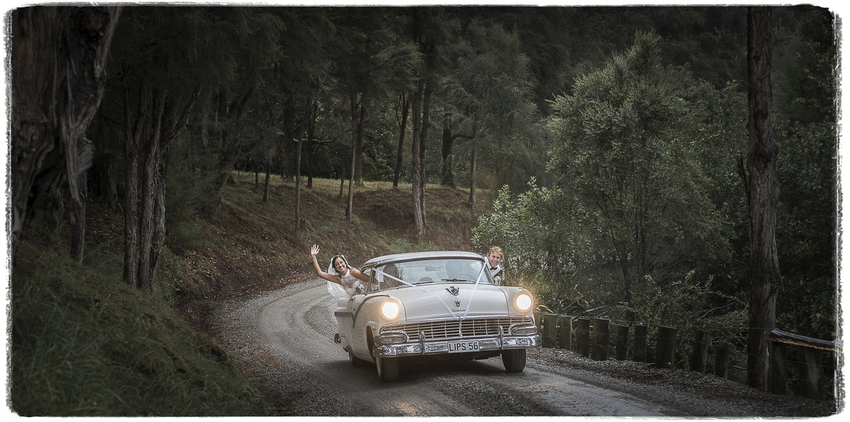 Bride & Groom Hang from car in beautiful woodland setting