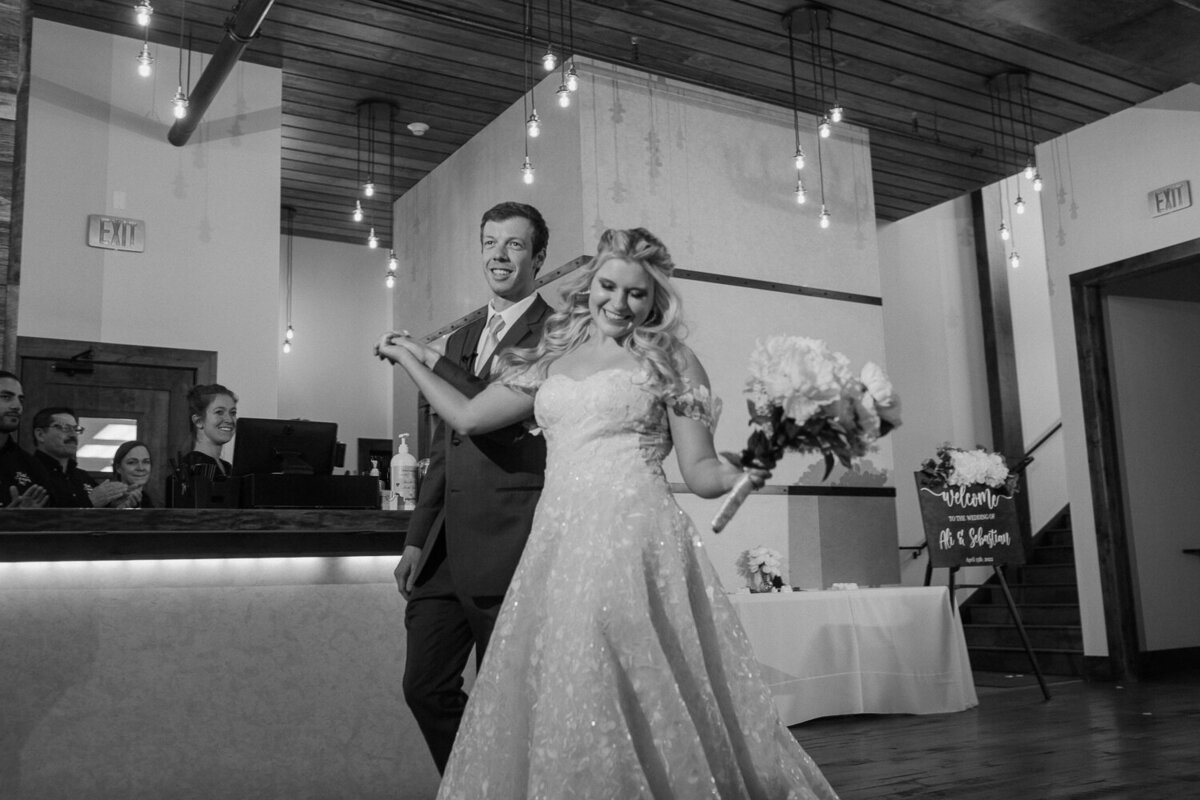 A bride and groom dance as they enter their reception hall during their Estes Park wedding.