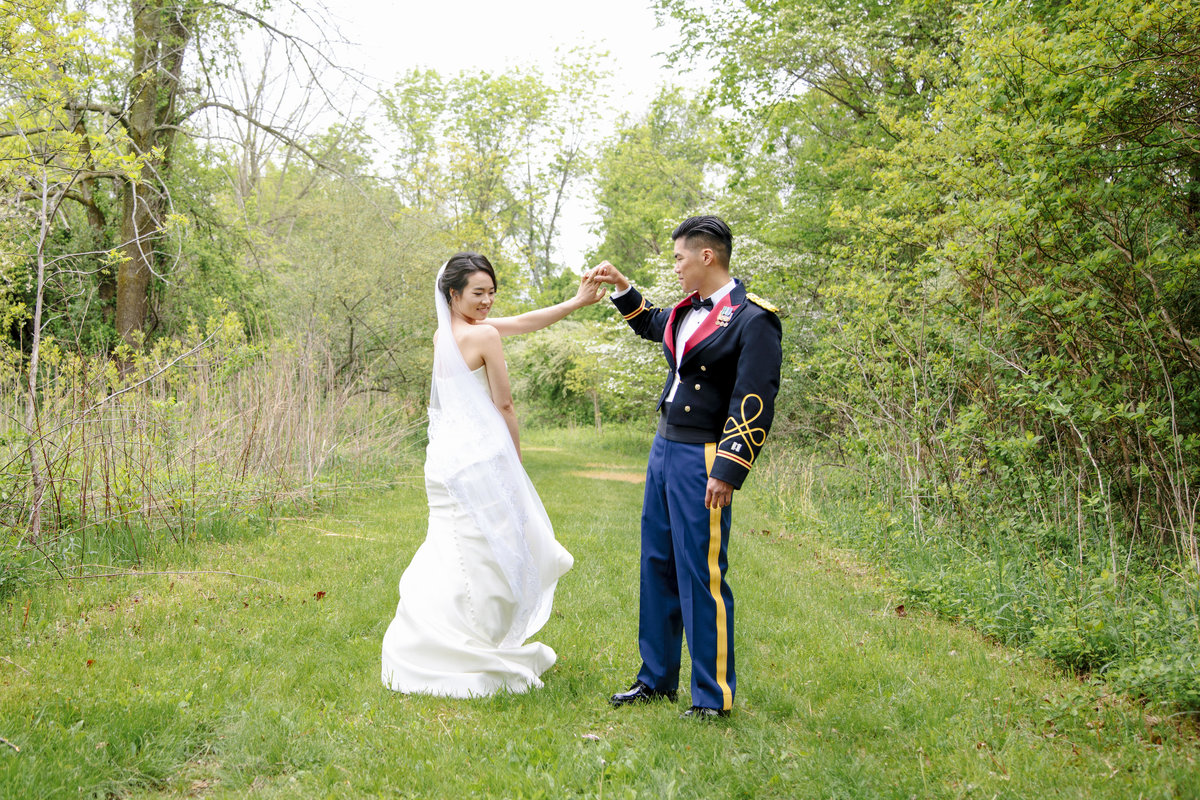 bride and groom dancing  in open field