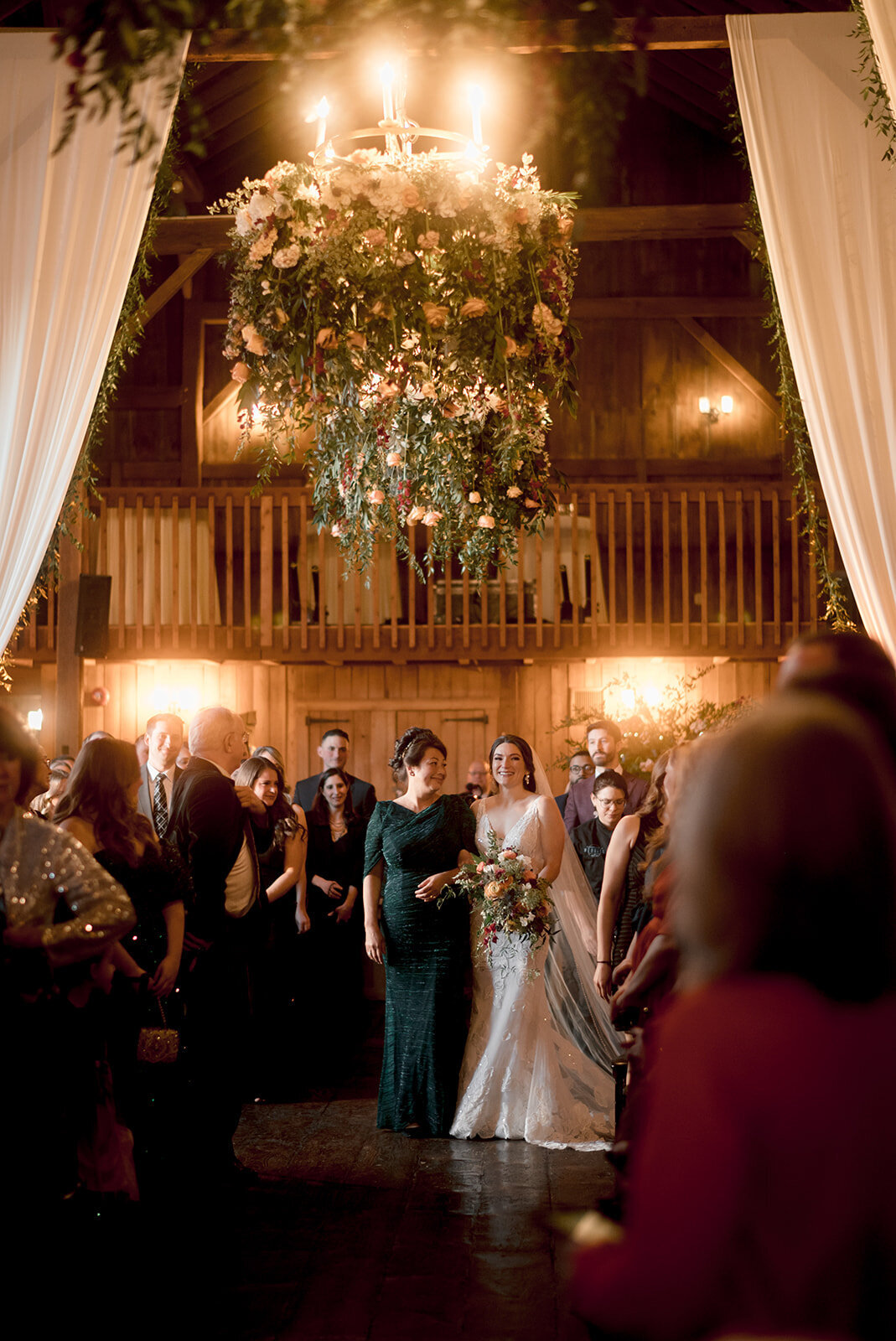 bride stands at end of aisle during her ceremony at barns at wesleyan hills wedding photo by cait fletcher photography