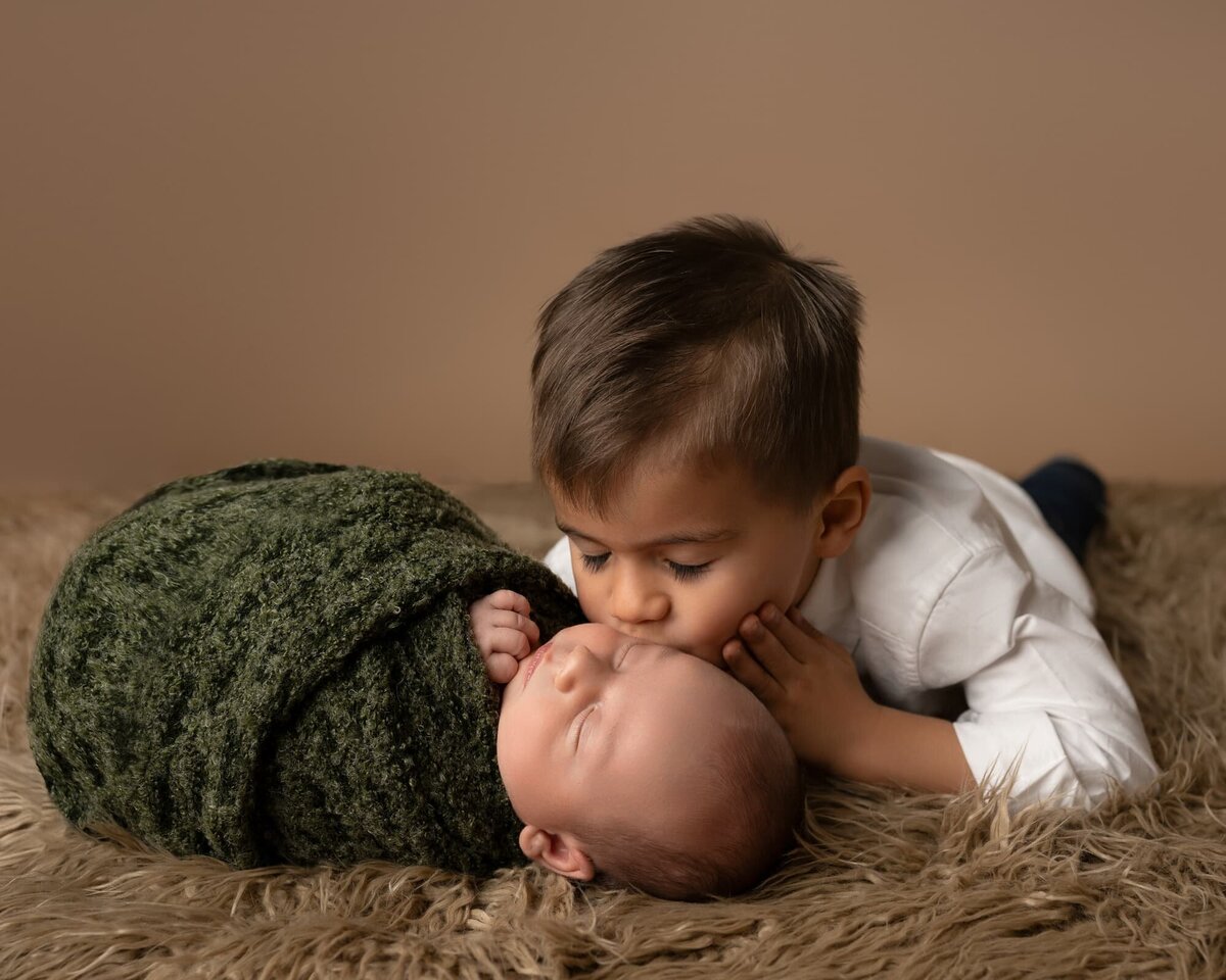 big-brother-kissing-newborn-baby-austin