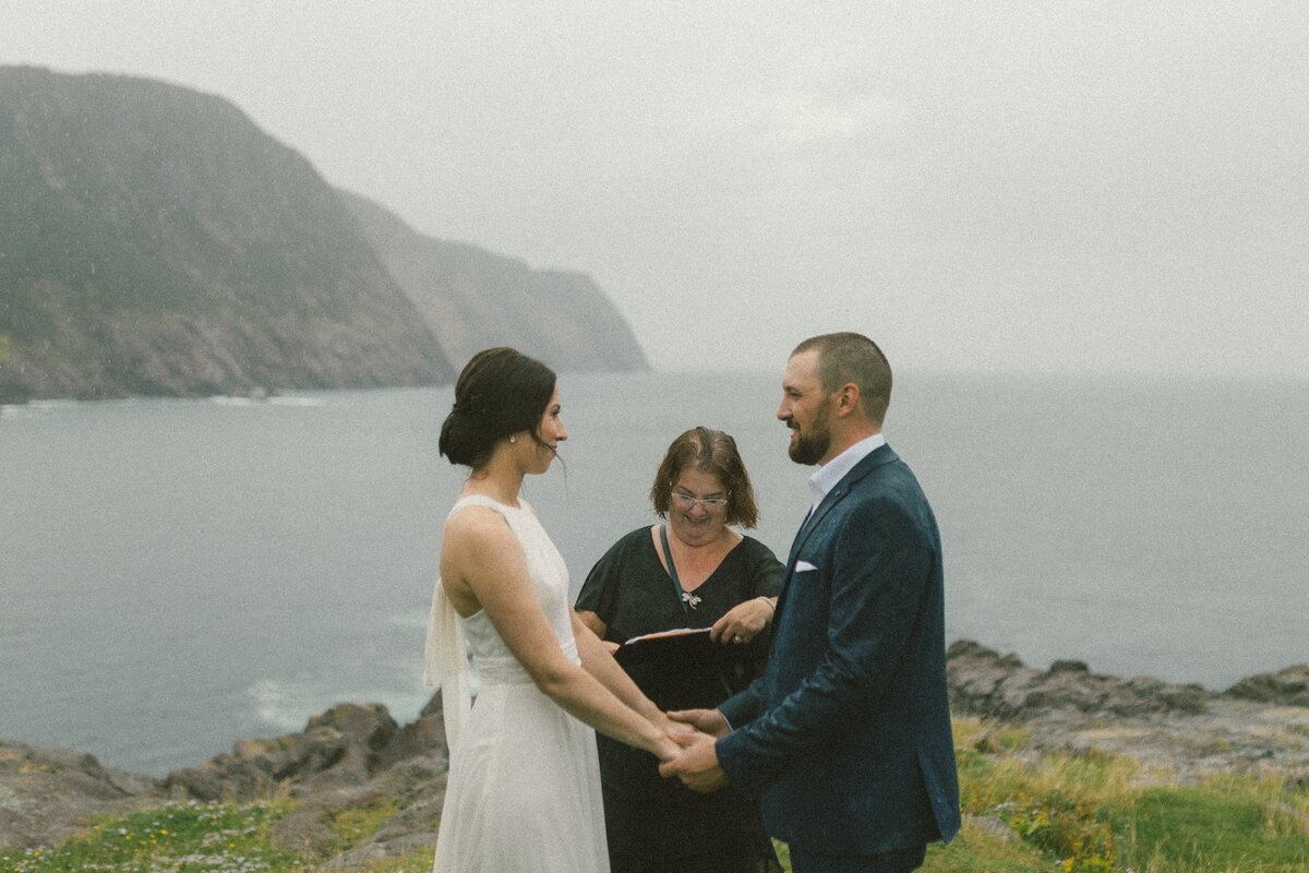 bride and groom at elopement wedding ceremony on the cliffs of Newfoundland