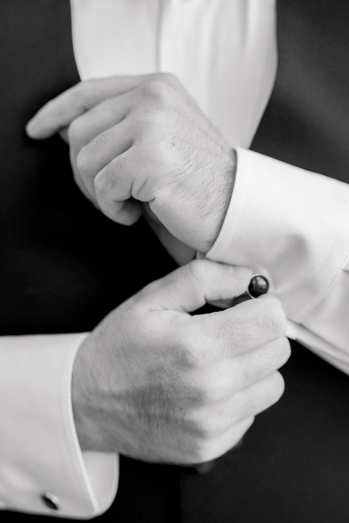 Bristol Train Station Wedding | black and white closeup of groom adjusting his cufflinks