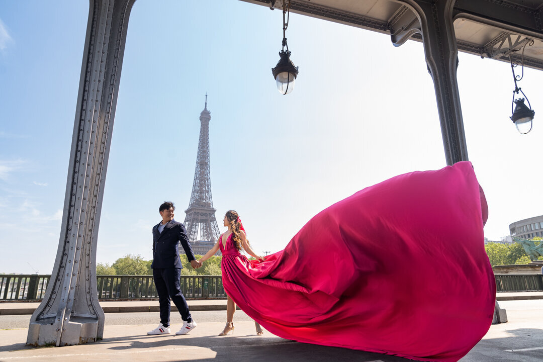 Paris couple photography Bir Hakeim Bridge, pink flying dress movement, Eiffel Tower background, professional photo session