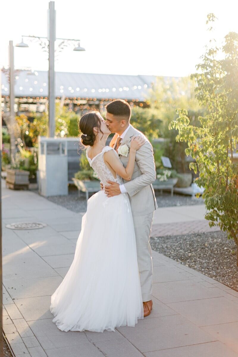bride and groom at sunset on wedding day at terrain