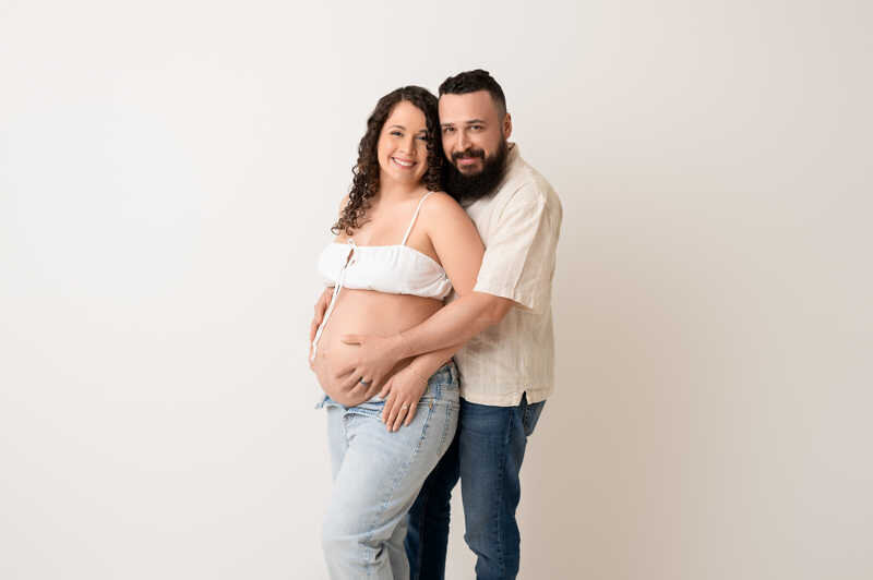 Expecting parents holding each other during Houston maternity photography session